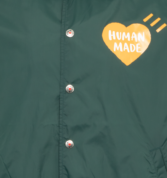 Image 3 of 4 - GREEN - HUMAN MADE Coach Jacket featuring pointed collar, button-down closure, screen-printed branding and acreen-printed graphics. Nylon/cotton blend. 