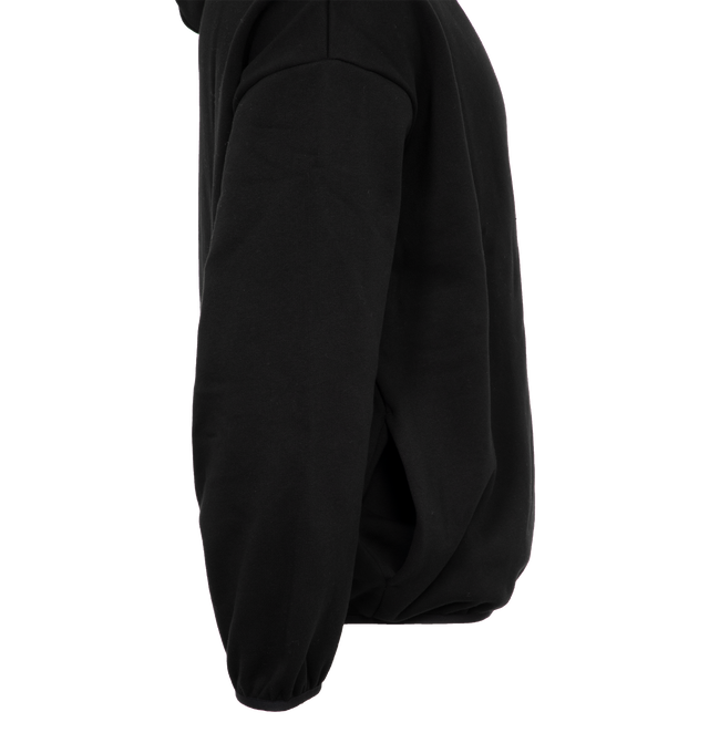 Image 3 of 4 - BLACK - FEAR OF GOD ESSENTIALS Hoodie featuring elastic waist and cuffs, fixed hood, side pockets and rubber logo on chest. 100% cotton.  
