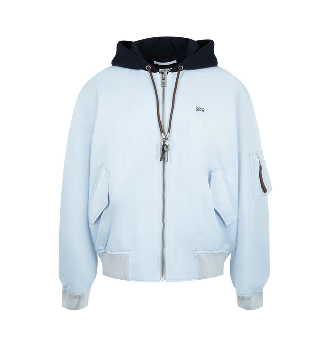 Image 1 of 3 - BLUE - Loewe Men's Bomber Jacket in Technical Shell is crafted from lightweight technical shell and features a regular-fit silhouette with a contrasting fleece hood. Designed with a zip-front closure, leather drawstring with detachable Anagram key ring detail, snap flap pockets, a sleeve zip pocket, interior welt pockets, ribbed cuffs and hem, and two-tone Anagram embroidery at the chest. Main Material: 100% Polyamide. Fully Lined. Made in Italy. 