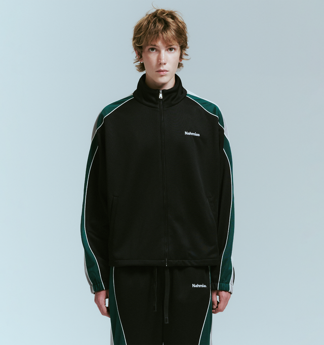 Image 2 of 4 - BLACK - NAHMIAS Ollie Track Jacket featuring zip front closure, stand collar, logo embroidery on chest, front slit pockets and stripes and piping down arms. 100% polyester.    
