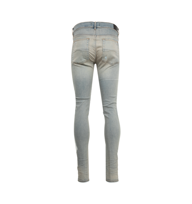 Image 2 of 4 - BLUE - AMIRI Bones Applique Distressed Jeans featuring white leather bones throughout side seams, distressed details throughout, tapered fit and ripped knees. 92% cotton, 6% elastomultiester, 2% elastane. 