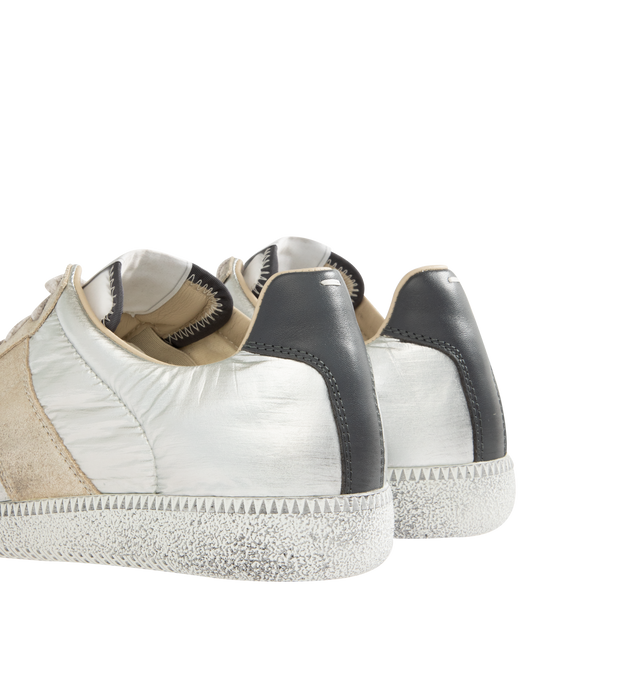 Image 3 of 5 - WHITE - MAISON MARGIELA Replica Sneakers featuring low-top, buffed nappa calfskin and calfskin suede, distressed throughout, lace-up closure, concealed elasticized gussets at vamp, logo patch at padded tongue, padded collar, white stitching at heel tab and treaded rubber sole. Upper: calfskin. Sole: rubber. Made in Italy. 