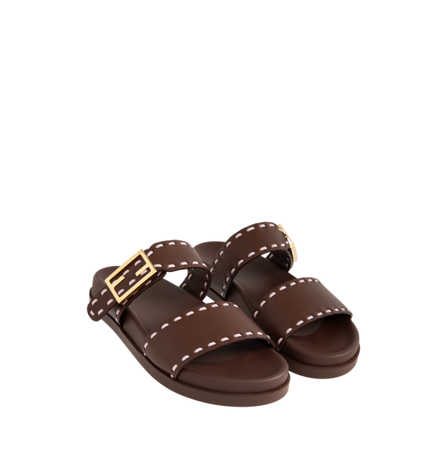 Image 2 of 4 - BROWN - FENDI Feel Slide Sandal featuring double-band flat slides with FF Baguette decorative buckle, hand-sewn contrasting macro Selleria topstitches and gold-finish metalware. 100% calfskin. Made in Italy. 