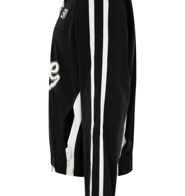 Image 3 of 3 - BLACK - RHUDE Ski Track Jacket featuring funnel neck, two-way zip closure, text and logo printed at front, welt and seam pockets, elasticized hem, stripes at side seams and sleeves and full satin lining. 100% polyester. Made in United States. 