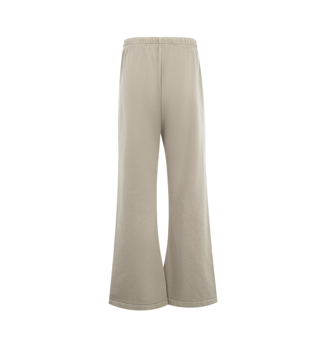 Image 2 of 3 - NEUTRAL - FEAR OF GOD ESSENTIALS Training Classic Flare Sweatpant featuring 390GSM core fleece, relaxed silhouette extends into a flared leg, encased elastic waistband with elongated drawcords, side seam pockets, puff-printed Essentials training logo on the leg and an Essentials signature label at the center front. 80% cotton, 20% polyester. 