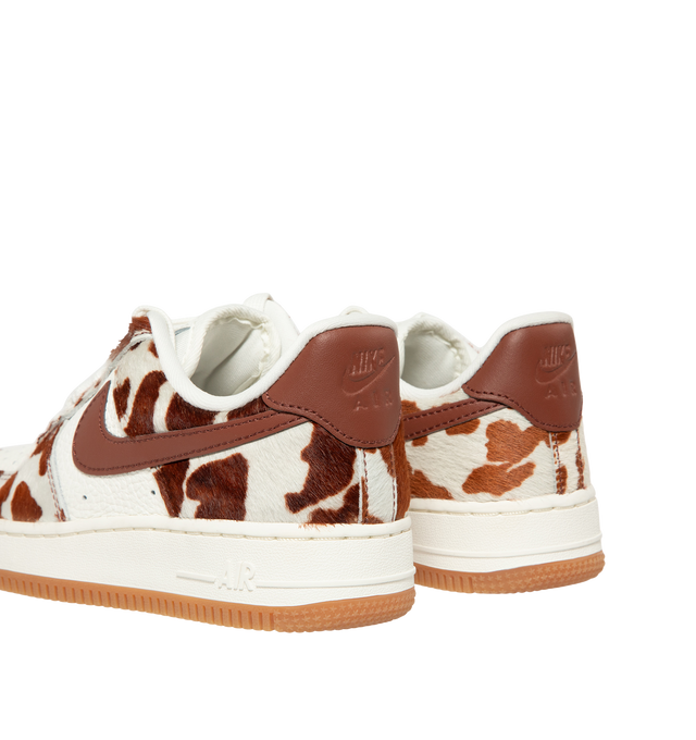 Image 3 of 5 - BROWN - Nike Womens Air Force 1 Sneakers are crafted from pony hair leather with smooth leather overlays. Feature a low-top silhouette, Nike Air cushioning, padded collar, stitched overlays, and a durable rubber cupsole. Main Material: Pony Hair Leather, Leather; Outsole: Rubber. Imported. 