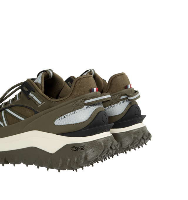 Image 4 of 5 - GREEN - MONCLER Trailgrip Sneakers featuring nubuck upper, mesh insole, lace closure, TPU spoiler, EVA midsole, carbon fiber between midsole and tread, vibram MEGAGRIP tread and ortholite insert. Sole height: 4.5 cm. 100% polyester. Lining: 100% polyamide/nylon. Sole: 100% elastodiene. Made in Vietnam.  