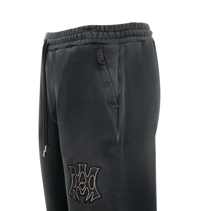 Image 5 of 6 - BLACK - Amiri MA Vintage Sweatpants have an elastic drawstring waist, overall distressing and fading, elastic ankles, side pockets, a brand logo patch, and a back patch pocket.  