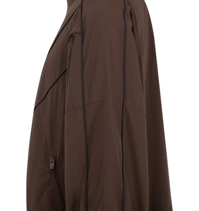 Image 3 of 3 - BROWN - Willy Chavarria Bad Boy Track Jacket is crafted from nylon and features a sleek, true-to-size silhouette defined by bold chevron paneling and contrast piping. Designed with a stand collar, front zip closure, two zippered pockets, stacked script logo detailing, and elasticized cuffs and hem. Main Material: 100% Nylon. Lining: Polyester. 