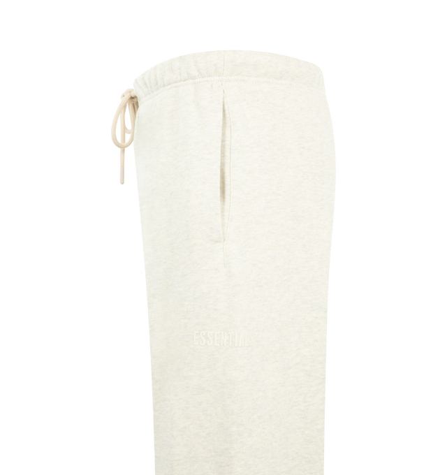 Image 3 of 3 - NEUTRAL - Fear of God Essentials Mens Classic Sweatpants are crafted from heavyweight 380 GSM cotton-blend core fleece. Feature a classic relaxed fit with tapered legs, elasticized waistband with bungee drawcord, side-seam pockets, elastic ankle cuffs, puff-printed Fear of God and Essentials branding, and an Essentials logo label. Main Material: 80% Cotton, 20% Polyester.  