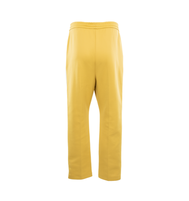 Image 2 of 4 - YELLOW - FEAR OF GOD Stripe Relaxed Sweatpant featuring a relaxed fit with a pintuck stitch to shape the leg and a sports-inspired canvas side stripe, pockets, encased elastic waistband, elongated drawstrings and Fear of God leather label at the center front. 60% nylon, 40% cotton. 