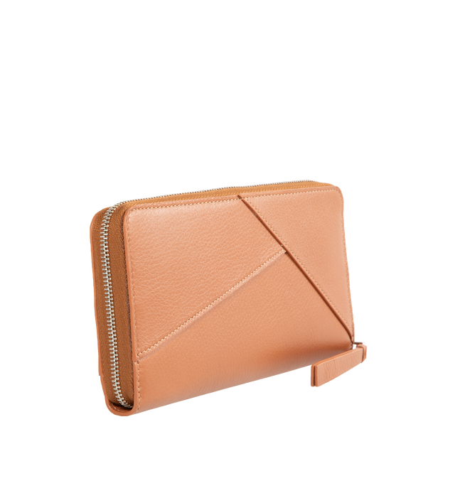 Image 2 of 3 - BROWN - LOEWE Puzzle Zip Around Wallet featuring distinctive geometric pattern, in classic calfskin with overlapped edges, twelve card slots and two large pockets for notes, two gusset sections, zipped coin compartment, calfskin zip pull and embossed Anagram. 4.1 x 7.5 x 0.8 inches. Calfskin. 