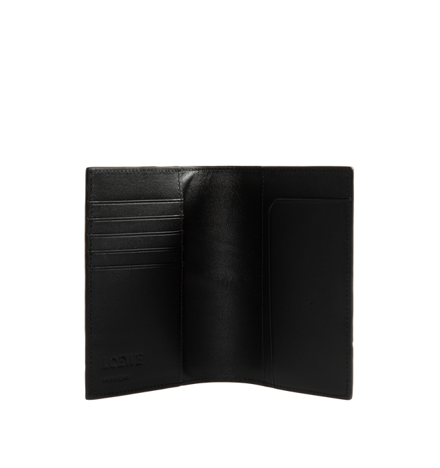 Image 3 of 3 - BLACK - Loewe Puzzle Passport Cover is crafted from supple grained calfskin leather and features the distinctive geometric pattern inspired by the iconic Puzzle bag. Designed to keep travel essentials organized, this passport holder is finished with five card slots, two interior flap pockets, an additional slip pocket, a calfskin lining, and an embossed Anagram logo. Main Material: Supple Grained Calfskin Leather. Lining: Calfskin Leather. Dimensions: 14 x 9.3 x 1.2 cm / 5.5 x 3.7 x 0.5 in. C 