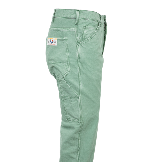 Image 3 of 4 - GREEN - HUMAN MADE Garment Dyed Painter Pants featuring straight cut, side pockets, garment dyed, carabiner hook, duck pocket patch and button fly. 100% cotton. 
