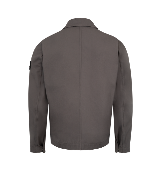 Image 2 of 3 - GREY - STONE ISLAND Coach Jacket featuring snap-fastened throat latch under collar to wear standing, waist-level top-entry patch pockets, vertical hand pockets with tape trim and concealed snap, three internal top-entry pockets; one with snap fastening that is visible on the exterior, Stone Island badge on left sleeve, adjustable cuffs with snap and snap fastening. 100% cotton. 