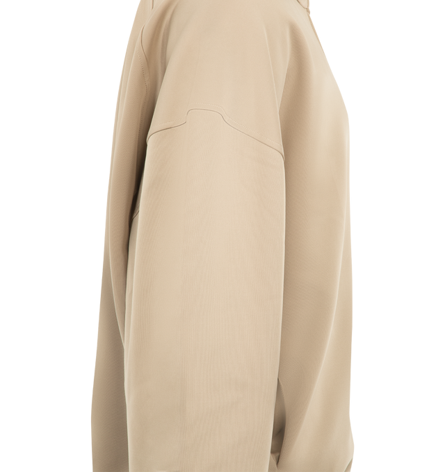 Image 3 of 3 - NEUTRAL - Fear of God ESSENTIALS Men's Tricot Modern Track Jacket is crafted from durable tricot knit and features a modern athletic silhouette with a full-zip front closure and high neckline. Designed for flexibility, comfort, and everyday performance, this elevated track jacket is detailed with dual embroidered logos at the front shoulders, side pockets, rib-knit cuffs and hem, and a signature label at the back. Main Material: 93% Polyester, 7% Elastane Tricot Knit.  