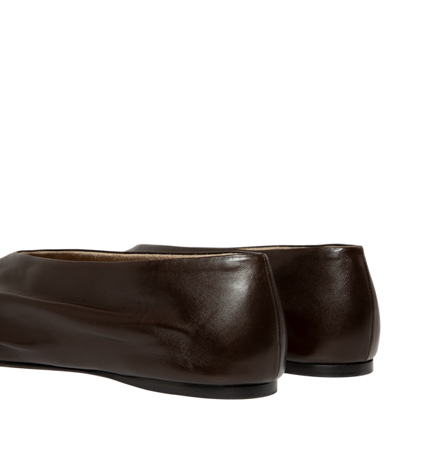 Image 3 of 4 - BROWN - Khaite Miriam ballerina flat inspired by the soft folds of fabric and crafted in Italy of glazed calfskin selected for its luminous shine. The deconstructed body is lined in cigar-hued suede, accentuating a natural fit that moves with the foot. Detailed with signature gold staple. Made in Italy. Glazed calf (100% calfskin). 