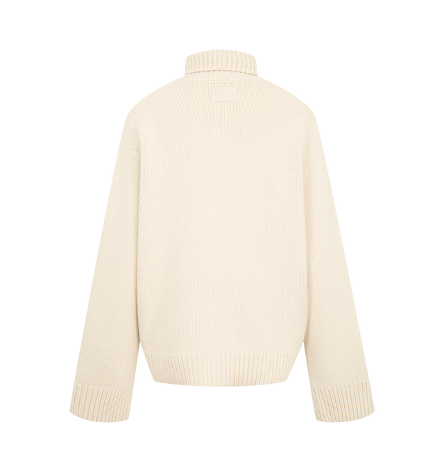 Image 2 of 2 - CREAM - Toteme Women's Oversized Turtleneck Sweater is knitted from a lambswool with a generous silhouette and cocooning, drop-shoulder construction. The high neck creates a sculptural frame while the tapered, ribbed hem and cuffs add structure. Materials: 100% RWS wool. 