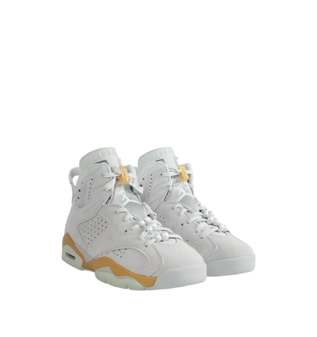 Image 2 of 5 - WHITE - Air Jordan 6 lace-up high top sneaker with a premium suede and textile upper. In celebration of the Paris Olympics, this Retro Pearl pair comes in smooth suede with metallic golden details and pearl lace charms on the laces. Features visible Air units in the forefoot and heel providing ample cushioning and explosive responsiveness. A large tongue with windows protects the top of the foot while providing ventilation. Lace toggle for a locked-in, customized fit. Large heel pull to slip  