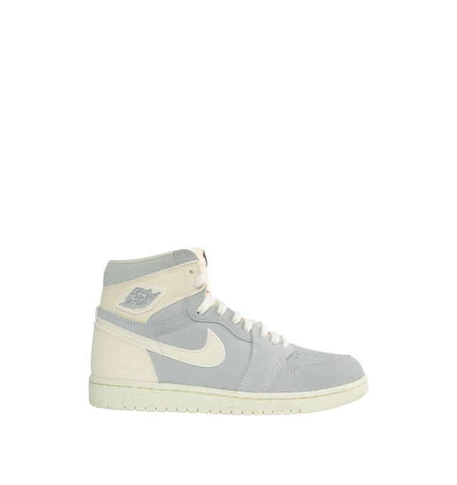 MULTI - NIKE AIR JORDAN 1 RETRO HIGH OG CRAFT IVORY features a real and synthetic leather in upper, encapsulated Nike Air unit, rubber in the outsole, wings logo on collar, embroidered Swoosh logo and Jumpman on tongue.