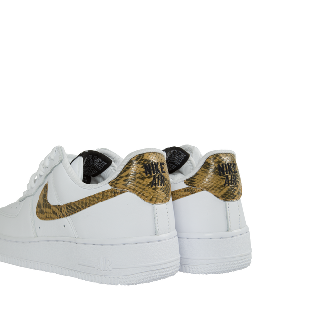 Image 3 of 5 - WHITE - Nike Air Force 1 Low Retro Premium 'Ivory Snake' in the coveted white, elemental gold, and dark hazel colorway. Features Nike Air cushioning, low-cut silhouette, padded collar, foam midsole, perforations on toe and rubber outsole. 