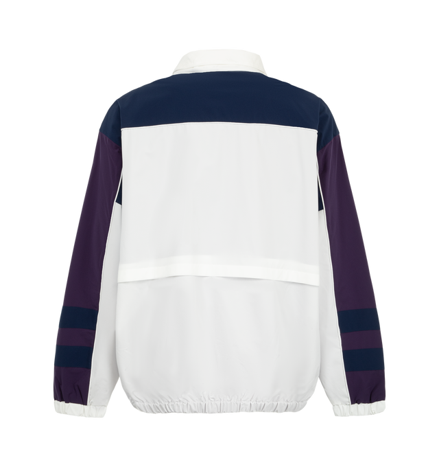 Image 2 of 3 - WHITE - Needles x Fila Men's Star Cut Oversized Windbreaker is crafted from polyester and features an oversized silhouette inspired by FILA's 1993 ski jacket, with bold color-blocked panels and sharp cut-line detailing. Created as part of the first collaboration between Needles and FILA, this lightweight outerwear style combines vintage performance influences with a contemporary streetwear aesthetic. Main Material: 100% Polyester. 