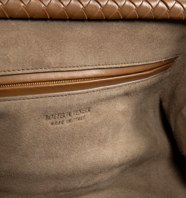 Image 3 of 3 - BROWN - Bottega Veneta Women's Intrecciato Lauren 1979 Elongated Clutch is crafted from Intrecciato leather and features an elongated silhouette, an adjustable shoulder strap, and a magnetic flap closure. Designed with a suede-lined interior, this versatile style includes a single compartment with a zip pocket and an internal hand mirror with a leather cover. Main Material: Leather. Lining: Suede. Hardware: Brass Vibrato Finish. Dimensions: 40 x 18 x 6 cm / 15.7 x 7.1 x 2.4 in. Strap Drop: 50 