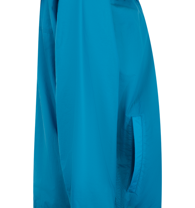 Image 3 of 3 - BLUE - Loewe Womens Technical Jacket is crafted from lightweight technical shell with a triple-layer construction. Features a relaxed fit, regular length, zip-up neckline with hood, front welt pockets, elasticated hem with drawstring, and Double L embroidery at the chest. Main Material: Polyamide / Polyurethane. Made in Italy. 