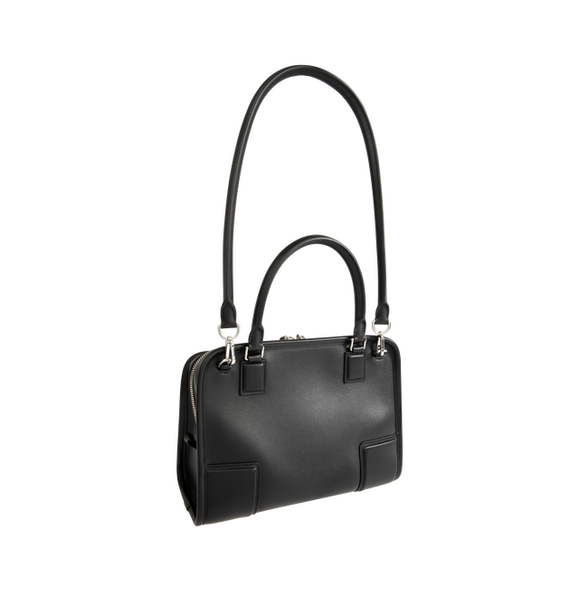 Image 3 of 5 - BLACK - Loewe Small Amazona 180 Bag in leather features a relaxed silhouette anchored by a single toron top handle, designed to be carried open, while a concealed closure secures the main compartment, three carry options: short handle, removable shoulder strap and crossbody, zip closure with two leather zip pullers, two compartments, main compartment closed with magnetic closure, internal flat pocket, left side d-ring for customization, nappa lambskin lining, and embossed double L branding. L 