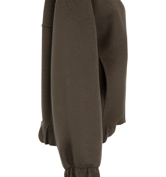 Image 4 of 4 - BROWN - Khaite Women's Cordan Jacket is crafted from double-face wool and features a cropped, relaxed bomber silhouette with signature armhole seaming, architectural topstitching, and softly rounded volume. Elasticated panels at the hem and cuffs, in-seam side pockets, and a front zip closure complete this designer wool jacket, combining exceptional craftsmanship with modern, sculptural tailoring for effortless everyday layering. Main Material: 100% Double-Face Wool. 
