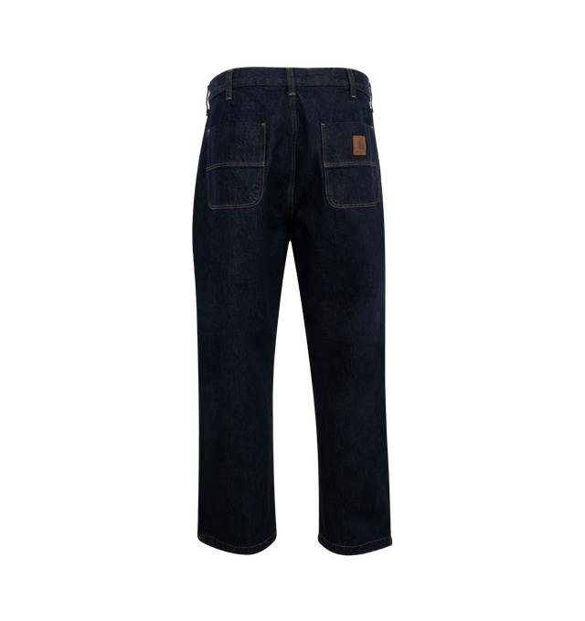 Image 2 of 3 - BLUE - Carhartt WIP Jace Pants are a 4-pocket style with a button fly, front pleats, contrast stitching, a faux leather logo patch on the back pocket, and a loose fit. 100% cotton. Made in Tunisia.  