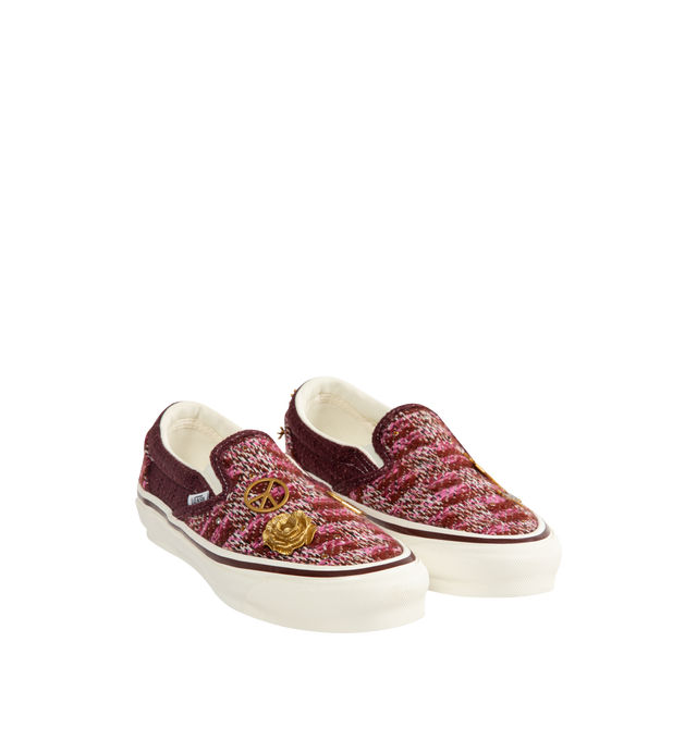 Image 2 of 5 - RED - Vans Unisex Premium LX Classic Slip-On 98 Cardigan Sneakers are crafted from multicolor knit cardigan textile and feature the brand's iconic laceless slip-on silhouette, decorative gold-tone hardware pins, and a padded collar for enhanced comfort. Main Material: Knit Textile; Hardware: Metal Pins; Outsole: Rubber. *Unisex style in men's sizing.   