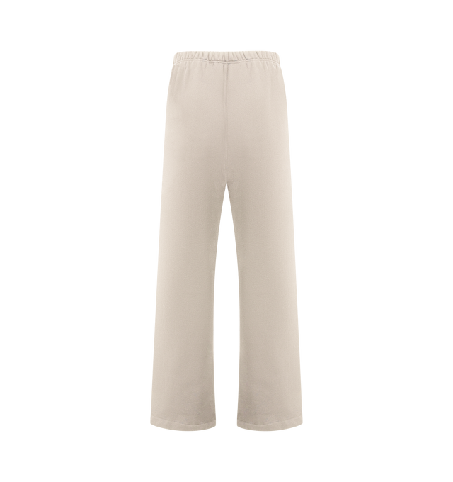 Image 2 of 3 - NEUTRAL - FEAR OF GOD ESSENTIALS Lounge Sweatpant featuring core fleece treated with a vintage wash, wide-leg silhouette, a 26 HD print graphic on the leg, encased elastic waistband with elongated drawcords, side seam pockets and a Fear of God Essentials rubberized label stitched at the center front. 100% cotton. 