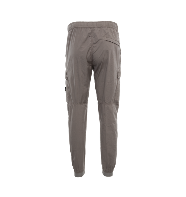 Image 2 of 4 - GREY - STONE ISLAND Tapered Pant featuring mid-rise, tapered leg, crinkled finish, signature detachable Compass badge, elasticated waistband with internal drawstring, concealed front zip fastening, two side zip-fastening pockets, rear press-stud fastening pocket, two side cargo pockets and elasticated cuffs. 