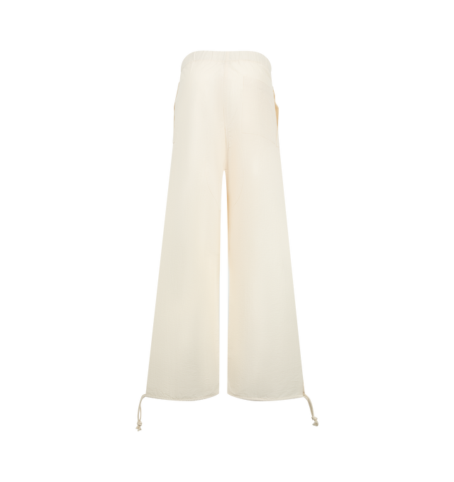 Image 2 of 3 - NEUTRAL - JW Anderson Women's Parachute Track Pants in ivory textured cotton nylon. Inspired by vintage Swedish utility trousers, in a relaxed fit. A wide leg silhouette with ties at the bottom, features leg pockets with concealed fastenings. Finished with a horn button fly and logo embroidery details. Composition 89% Cotton; 11% Polyamide. Made in Italy. 