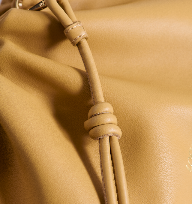 Image 4 of 4 - BROWN - LOEWE Flamenco Mini Napa Drawstring Clutch Bag featuring suede lining, coiled knot drawstring and hidden magnetic closure. 7"H x 9.4"W x 3.5"D. Convertible shoulder strap: 11 1/2" 23 1/2" drop. Nappa calf. Made in Spain. 