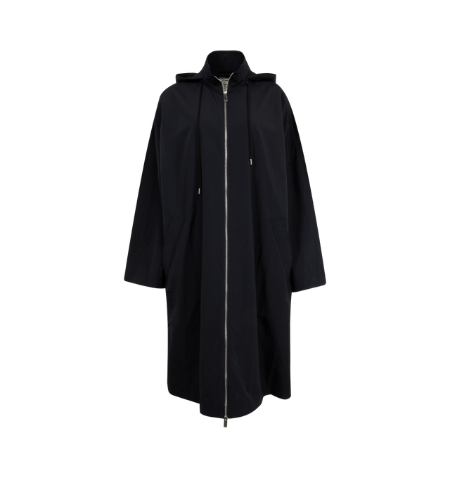 Image 1 of 3 - BLUE - TOTEME Windbreaker Coat featuring a practical stowaway hood with drawcords, oversized silhouette with low shoulders, a front zipper and welt pockets. 100% polyamide recycled. 