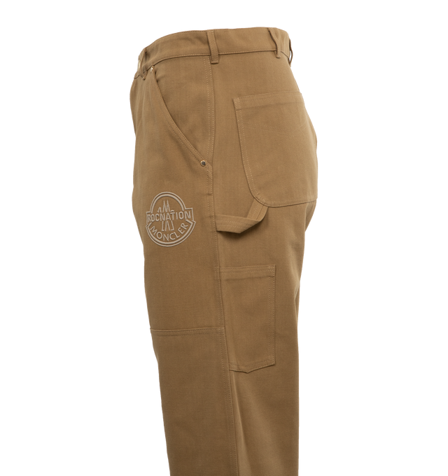 Image 3 of 4 - BROWN - MONCLER GENIUS MONCLER X ROC NATION BY JAY-Z TROUSERS are a cargo pant style with a snap closure and side slit pockets. Fits true to size. 100% cotton. 