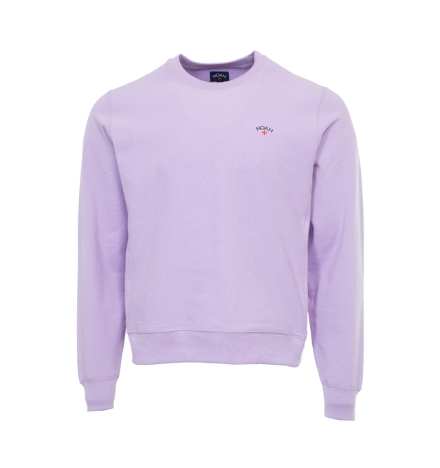 Image 1 of 3 - PURPLE - NOAH Core Logo Pocket T-shirt featuring embroidered logo on chest, crew neck, long sleeves and ribbed cuffs, hem and collar. 100% cotton.  