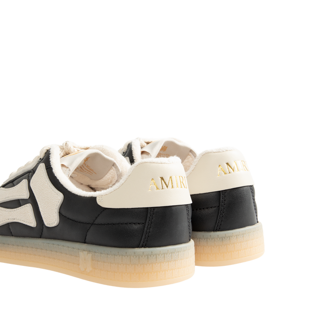 Image 3 of 5 - BLACK - Amiri Mens Pacific Football Sneakers are crafted with a leather upper and signature pebbled leather bone appliqus. Feature contrast topstitching, lace-up closure, padded collar, two-tone rubber sole, and low-top silhouette. Main Material: Leather Upper; Sole: Rubber. Made in Vietnam. 