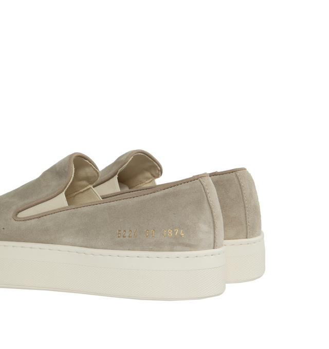 Image 3 of 5 - NEUTRAL - Common Projects minimalist slip-on sneaker crafted from calf suede in a sleek, round-toe profile with thick rubber soles detailed at the heels with signature gold serial number stamp. Made in Italy. 