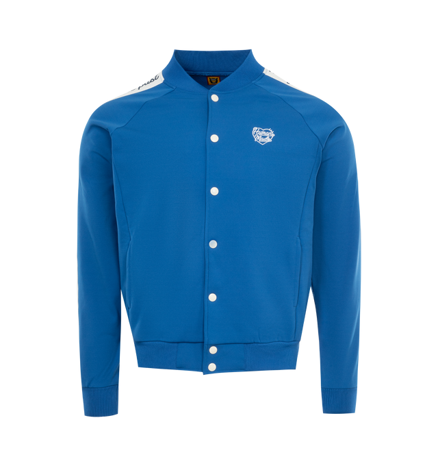 Image 1 of 2 - BLUE - HUMAN MADE Track Jacket featuring button front closure, "THE FUTURE IS IN THE PAST" text graphic on both sides, stand collar and side pockets. 100% polyester.  
