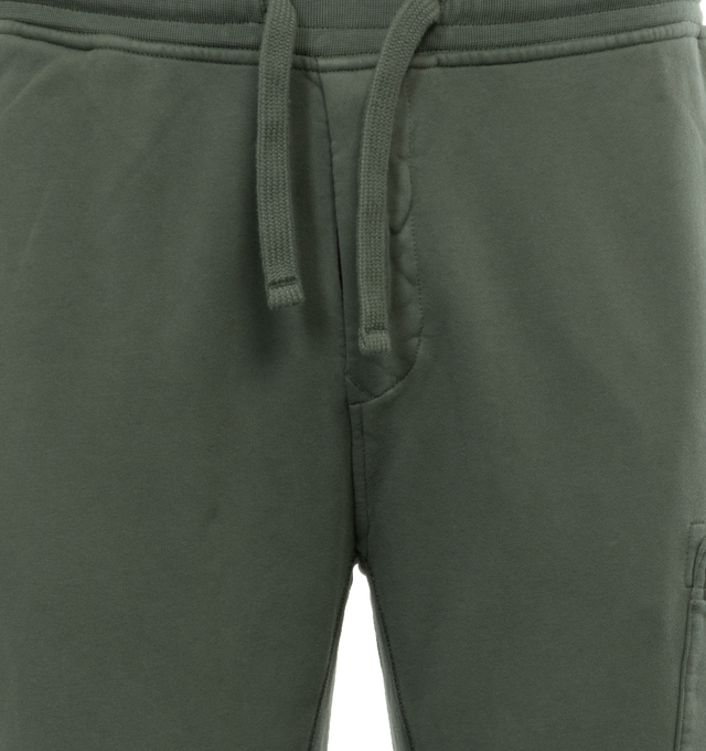 Image 4 of 4 - GREEN - STONE ISLAND Cargo Sweatpants featuring in-seam pockets, one back pocket with hidden snap fastening, patch pocket on the left leg featuring the Stone Island badge, hidden zipper closure, elasticized waist with outer drawstring, ribbed leg bottoms and zipper closure. 100% cotton. 