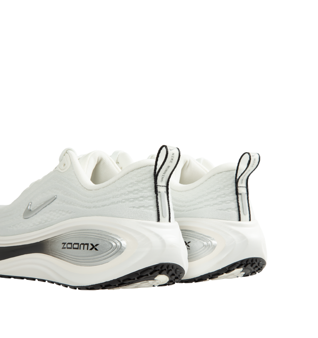 Image 3 of 5 - WHITE - Nike Women's Vomero Plus Running Shoes are engineered with a full-length ZoomX foam midsole and feature Nike's highest level of cushioning for an ultra-soft, responsive ride. Designed for everyday road running, this max-cushion silhouette combines a breathable engineered mesh upper with a high-stack platform and durable rubber outsole for lasting comfort and traction. Main Material: Engineered Mesh. Midsole: Full-Length ZoomX Foam. Outsole: High-Abrasion Rubber. Weight: Approx. 242 g  