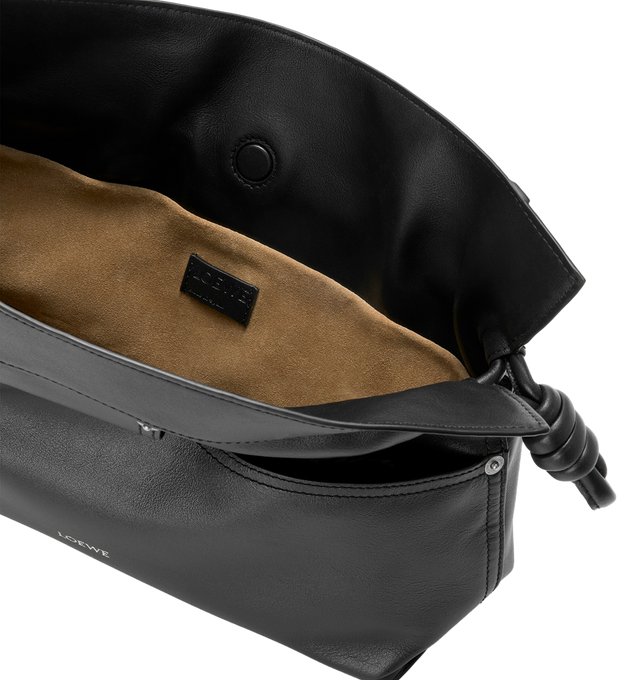 Image 4 of 4 - BLACK - LOEWE Panta Flamenco Medium Clutch in shiny calfskin featuring a soft and slouchy bag with a cinched closure and historical knot drawstrings. This medium version is crafted in shiny calfskin with denim trousers-inspired details, shoulder, crossbody or hand carry, detachable and adjustable strap, magnetic closure, herringbone cotton canvas lining and silver embossed LOEWE. Shiny calf. 24.5 cm x 30 cm x 10.5 cm. Made in Spain. 