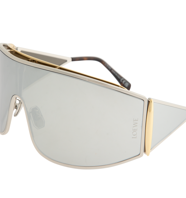 Image 3 of 3 - SILVER - LOEWE Speed Shield Sunglasses featuring shield-shape in a wraparound metal construction with a lens that extends into a distinctive triangle-shaped temple, complemented by contrast trim, universal fit, UVA/UVB protection and engraved LOEWE. Metal. Temple size: 12 cm. Made in Italy. 