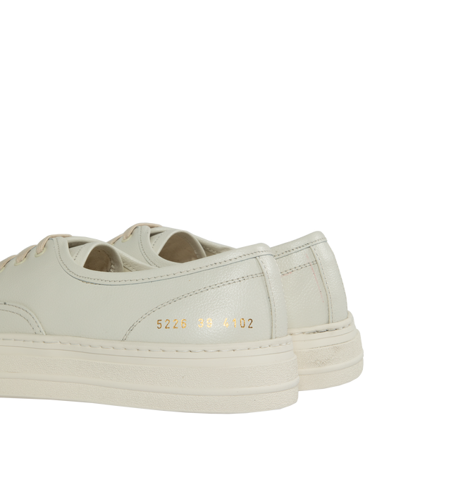 Image 3 of 5 - WHITE - Common Projects Four Hole Lace-Up Sneakers in a low-top design with flat sole, front lace-up fastening, round toe detailed with signature gold number stamp at the heel. Made in Italy. 