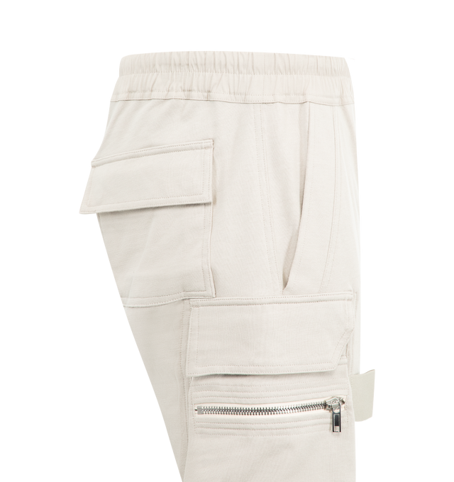 Image 3 of 3 - WHITE - RICK OWENS Mastadon Cargo Pants featuring slim-fit, stretch GOTS-certified organic cotton, drawstring at elasticized waistband, four-pocket styling, button fly, pen slots at front, elasticized cuffs and cargo and zip pocket at outseams. 97% cotton, 3% elastane. Made in Italy. 