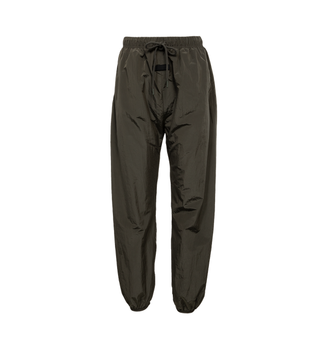 BLACK - FEAR OF GOD ESSENTIALS Nylon Track Pants featuring drawstring at elasticized waistband, rubberized logo patch at front, two-pocket styling, zip vent at elasticized cuffs and fully lined. 100% nylon. Lining: 100% polyester. Made in China.