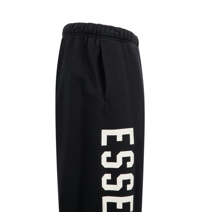 Image 3 of 3 - BLACK - FEAR OF GOD ESSENTIALS Heavy fleece relaxed fit sweatpant featuring a wide leg, elasticated waistband, drawstring fastening, and side pockets. 100% Cotton. 